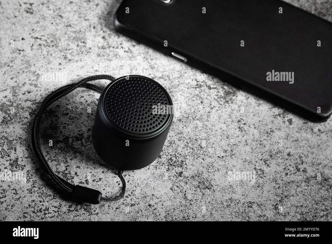 Black mini Bluetooth speaker and smartphone conected Stock Photo