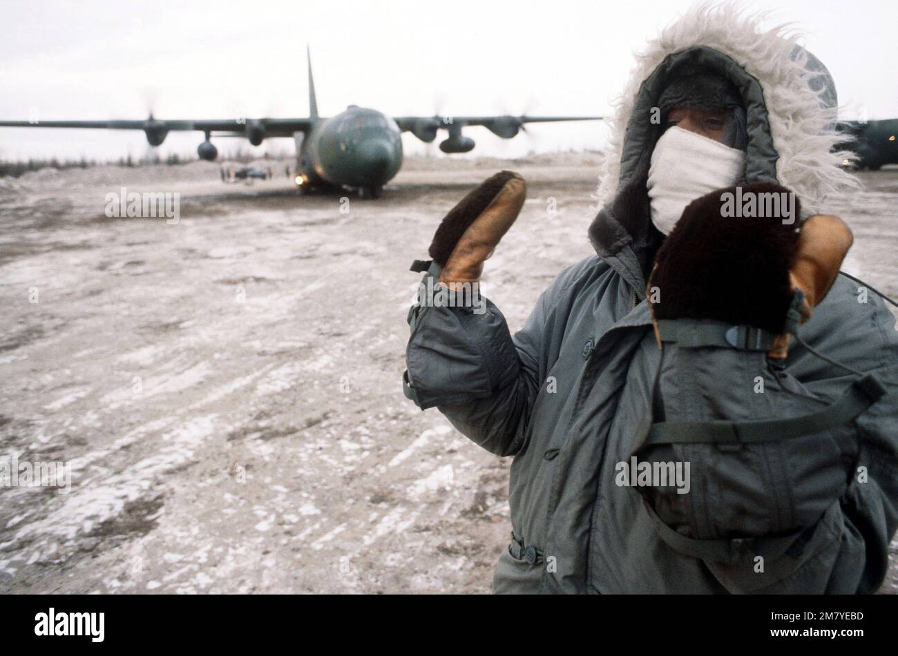 AIRMAN 1ST Class Craig Bass signals an aircraft as it arrives with Army ...