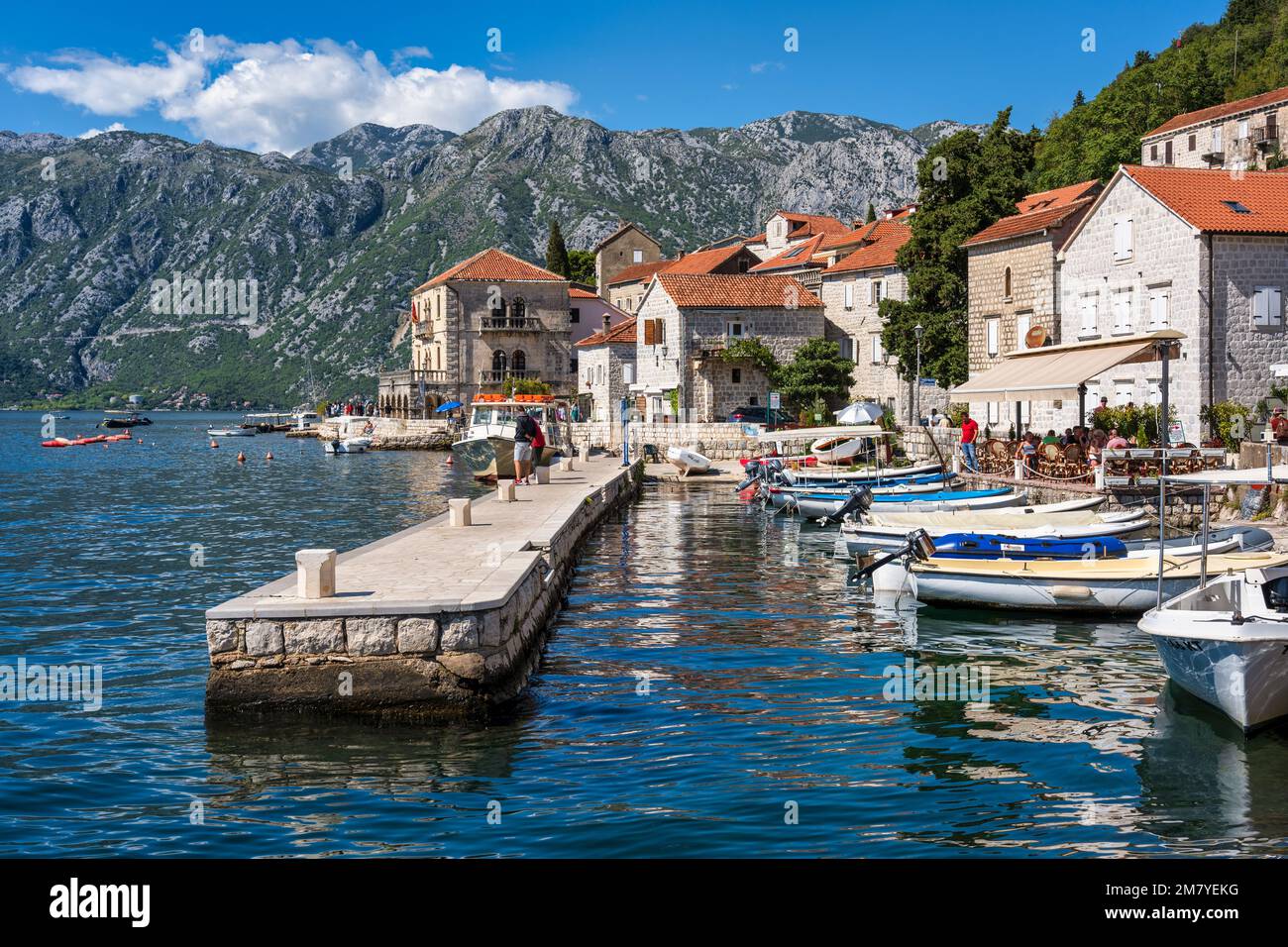 Boats tied up in one of the many small harbours on the waterfront of Perast on the Bay of Kotor in Montenegro Stock Photo