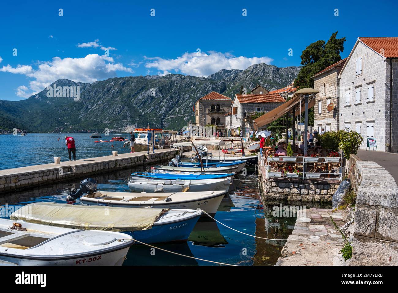 Boats tied up in one of the many small harbours on the waterfront of Perast on the Bay of Kotor in Montenegro Stock Photo
