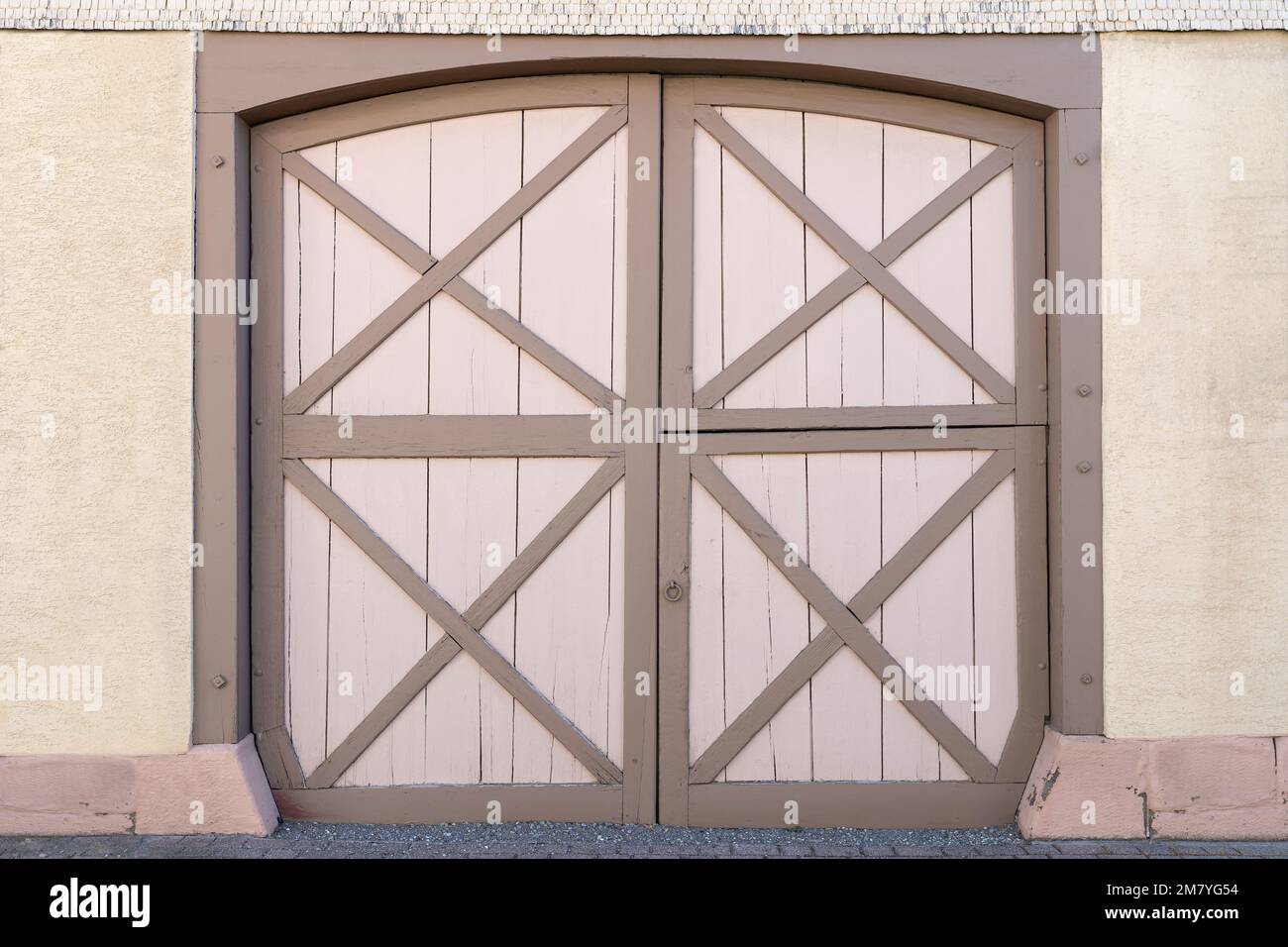 Large old barn door with pattern of crossed boards Stock Photo