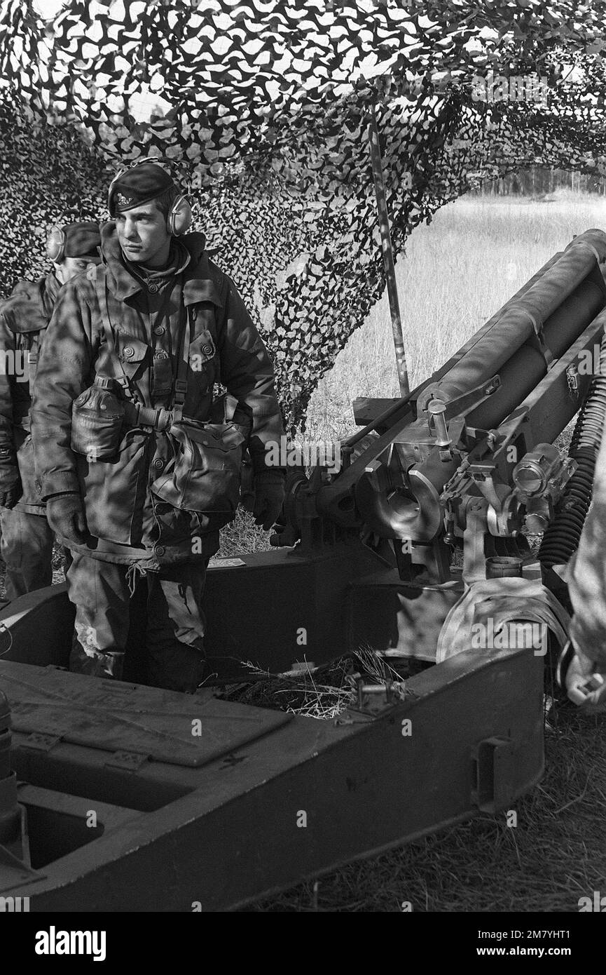 GUNNER Bertrand Ramallard, one of 108 visiting Canadians from Battery X, 5th Light Artillery Regiment, stands by his howitzer awaiting further firing orders during a field exercise. The Canadians swapped places with Battery C, 1ST Battalion, 321st Field Artillery, who deployed to Canada for a month of training. Base: Fort Campbell State: Kentucky (KY) Country: United States Of America (USA) Stock Photo