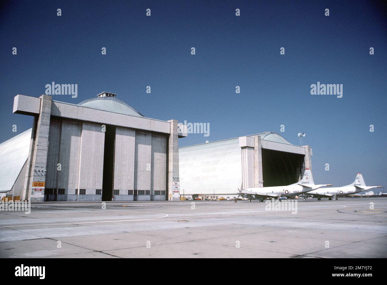 A left side view of two Patrol Squadron 46 (VP-46) P-3 Orion aircraft parked in front of a hangar. Base: Naval Air Station, Moffett Field State: California (CA) Country: United States Of America (USA) Stock Photo