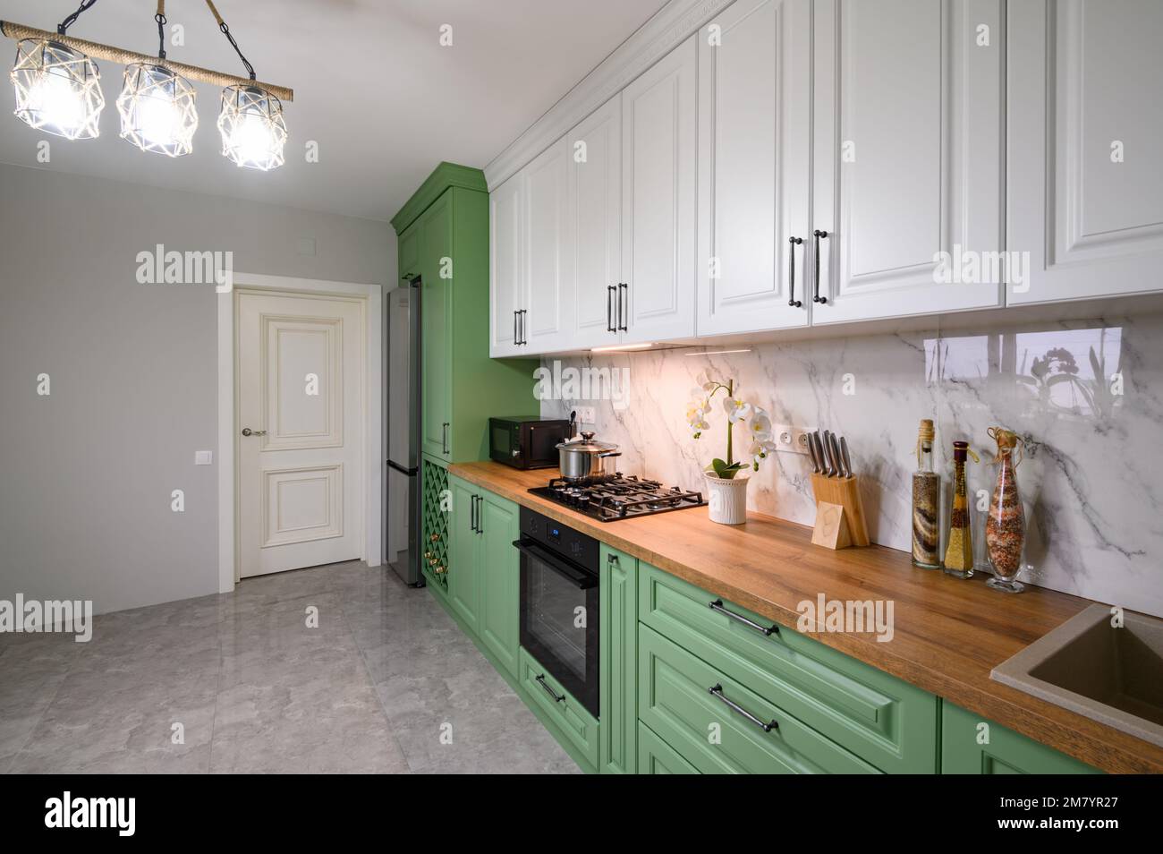 Green and white colored modern kitchen detail Stock Photo