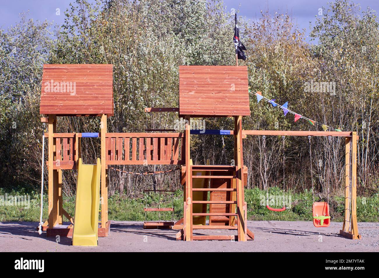 Outdoor playset for toddlers and kids made of wood and plastic Stock