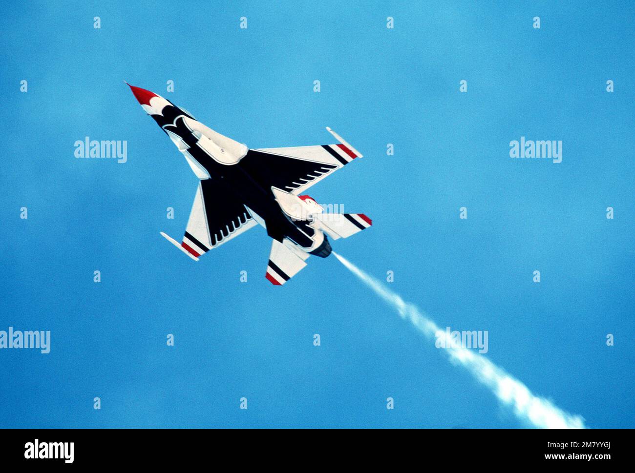 An airtoair bottom view of an F16 Fighting Falcon aircraft as the Air Force Thunderbirds