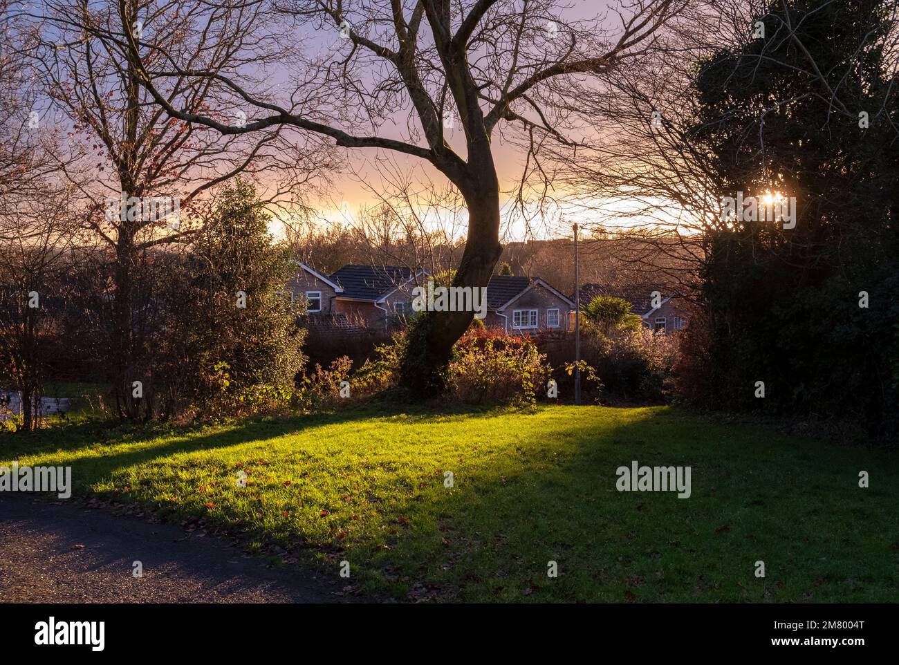 Winter sunlight setting on an urban scene casting a glow over the landscape, Worcestershire, England. Stock Photo