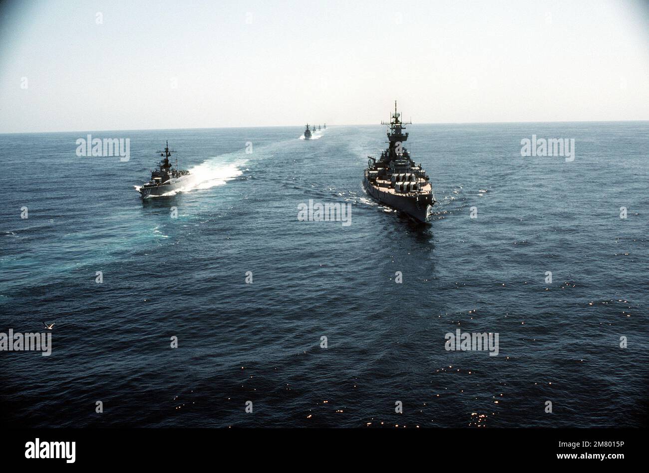 Aerial bow view of the battleship USS NEW JERSEY (BB-62) (right) and the frigate USS SAMPLE (FF-1048). The ships are part of a task group underway off the coast of California. Country: Pacific Ocean (POC) Stock Photo