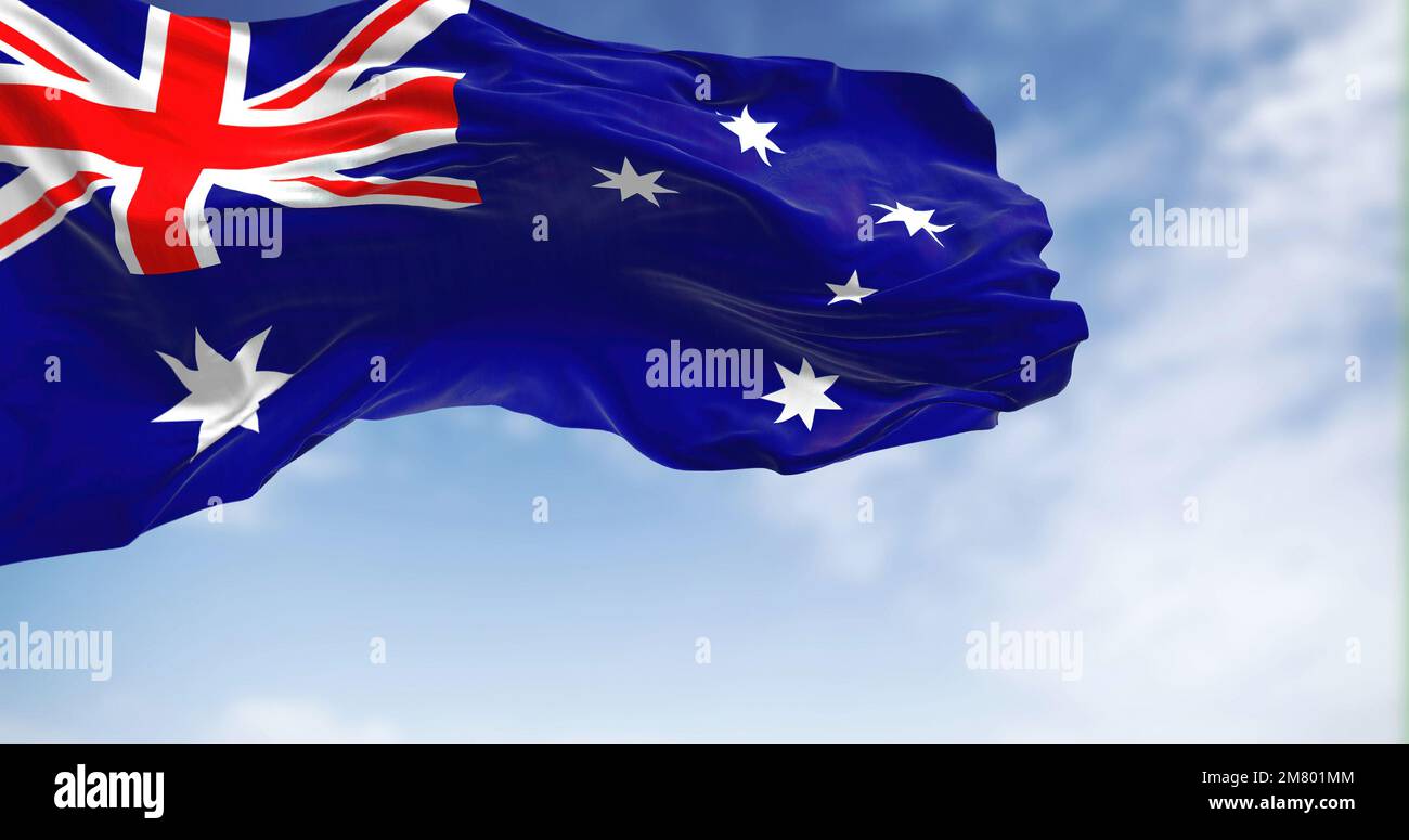 Australia national flag waving in the wind on a clear day. Blue flag with Union Jack, white 5-pointed star symbolizing Southern Cross. Rippled fabric. Stock Photo