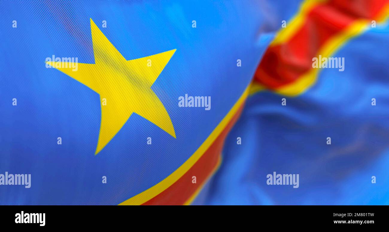 Close-up view of The Congo national flag waving. The Democratic Republic of the Congo is a State of Central Africa. Rippled Fabric. Textured backgroun Stock Photo