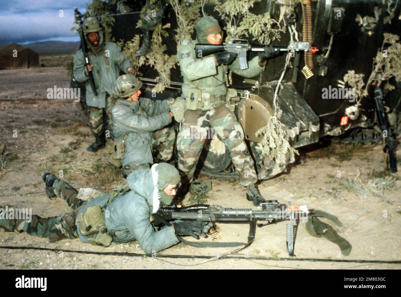 Two airmen prepare to fire an M60 machine gun and an M16A1 rifles during Exercise CROWN DEFENDER. Both weapons are equipped with the multiple integrated laser engagement system (MILES). Subject Operation/Series: CROWN DEFENDER Base: Fort Irwin State: California (CA) Country: United States Of America (USA) Stock Photo