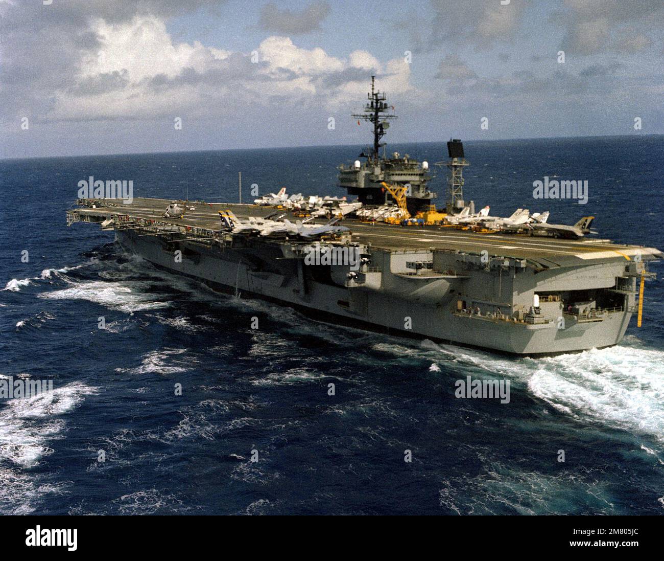 An aerial port quarter view of the aircraft carrier USS KITTY HAWK (CV ...