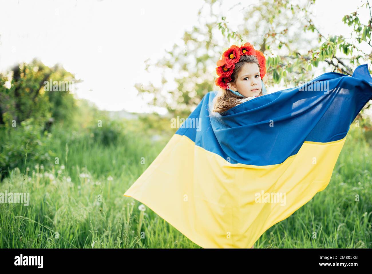 Ukraines Independence Flag Day. Constitution day. Ukrainian child girl in embroidered shirt vyshyvanka with yellow and blue flag of Ukraine in field. flag symbols of Ukraine. Kyiv, Kiev day Stock Photo