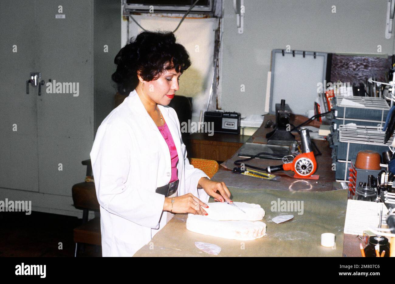 A specialist shapes the mold of a patient's foot for an insert to be