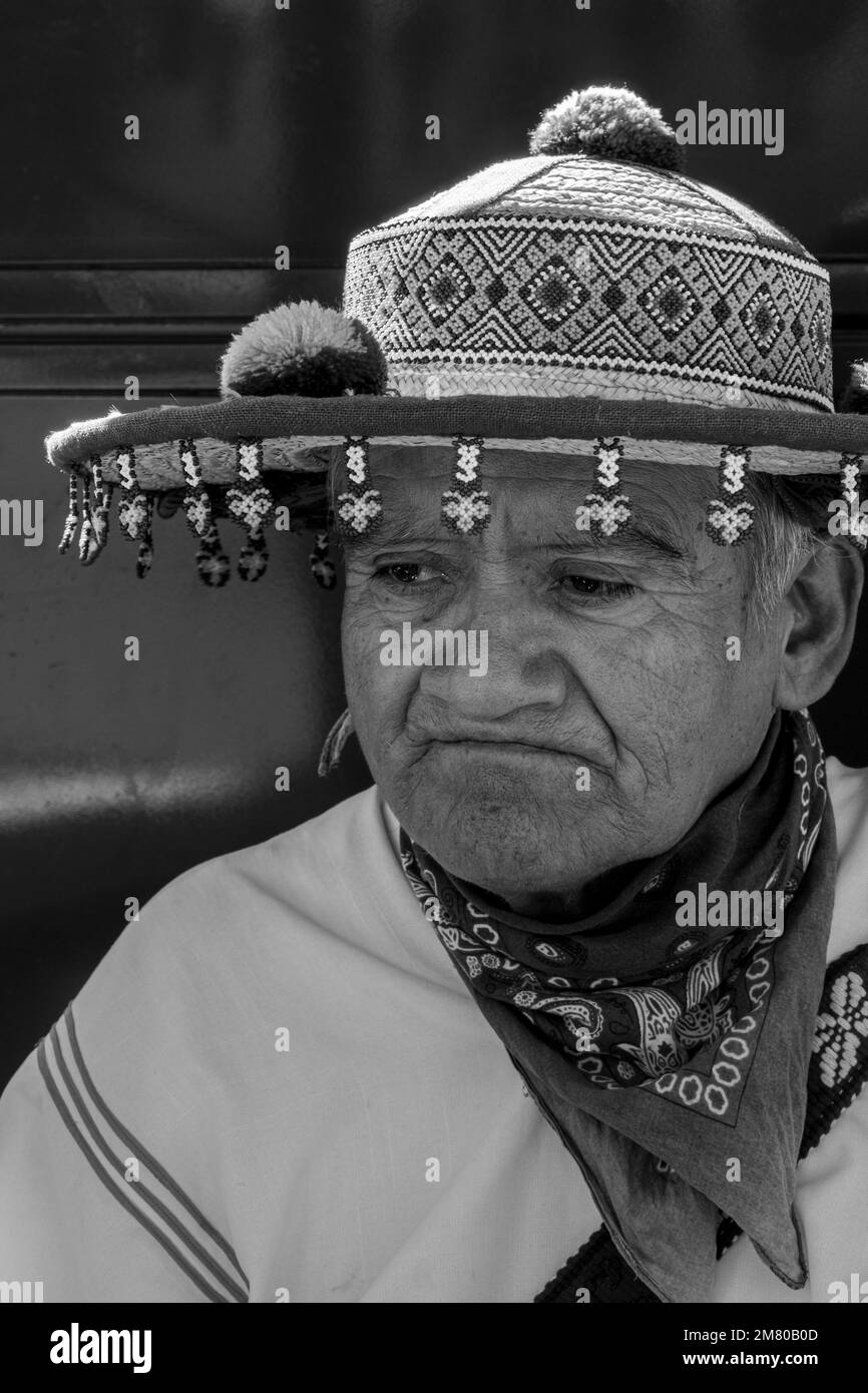 old man of the huichol wixarika culture with his traditional hat, selling his handicraft in mexico Stock Photo