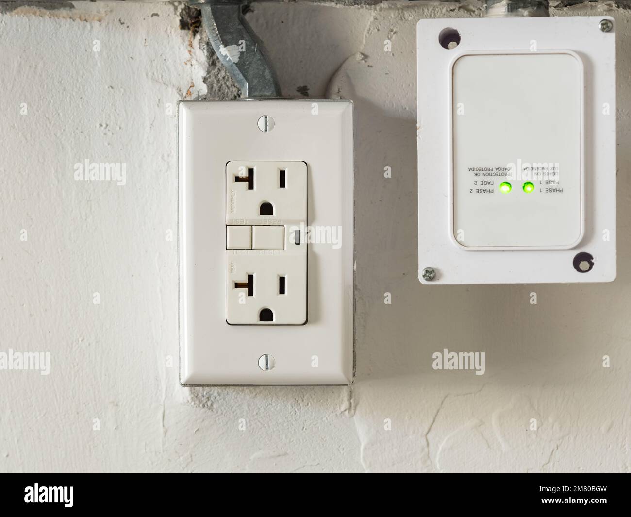 Ground fault interrupter electricity receptacle and wall plate. Residential gfci electric outlet plug with GFI reset button. Stock Photo
