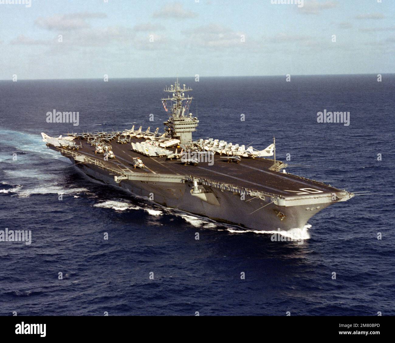 An aerial port bow view of the nuclear-powered aircraft carrier USS ...