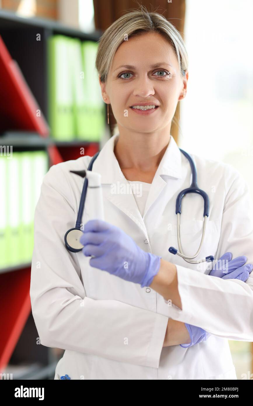Confident female doctor with stethoscope looks at camera. Stock Photo