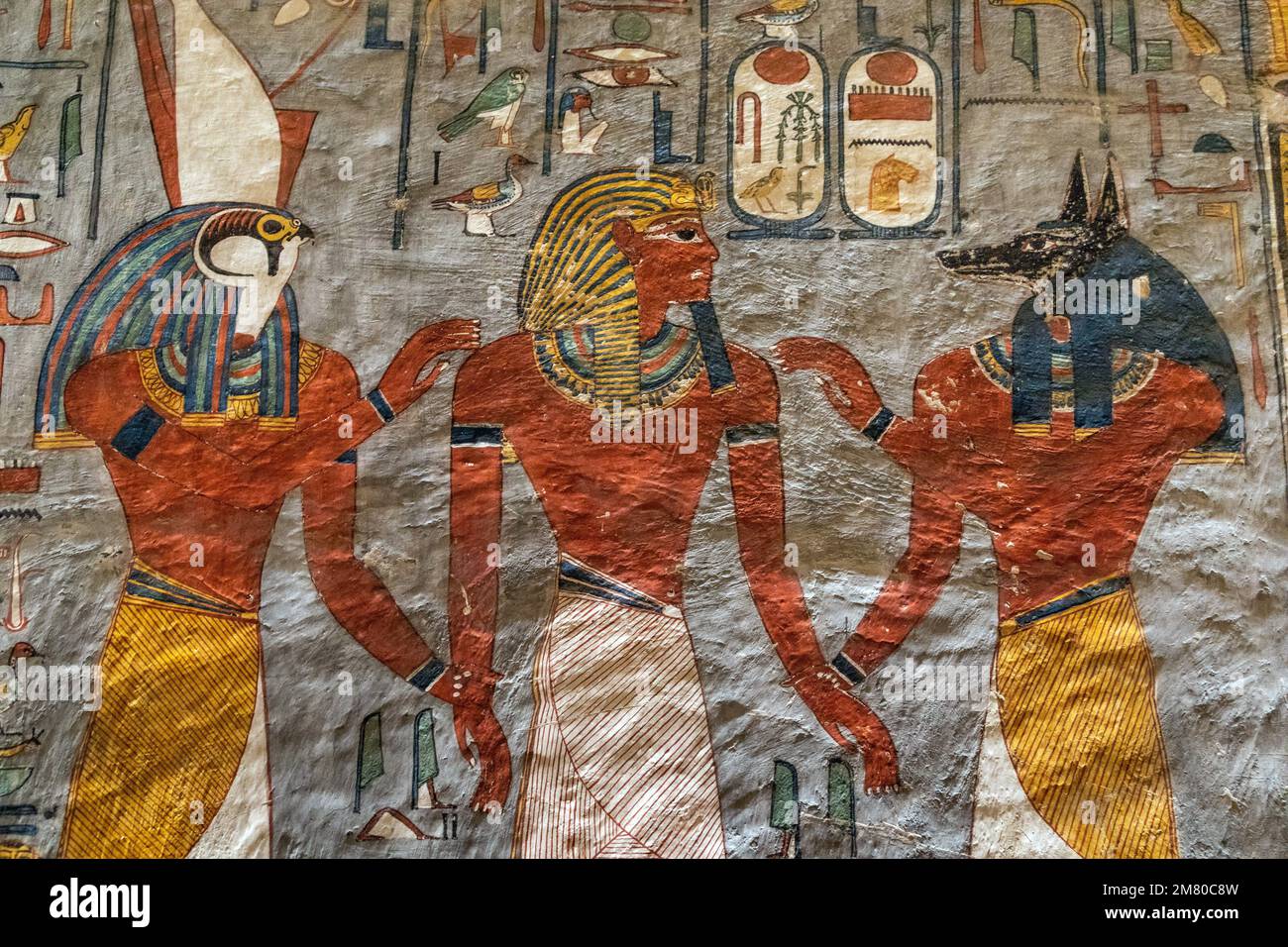 RAMSES FLANKED BY ANUBIS (FUNERARY GOD WITH THE HEAD OF A WILD DOG) AND