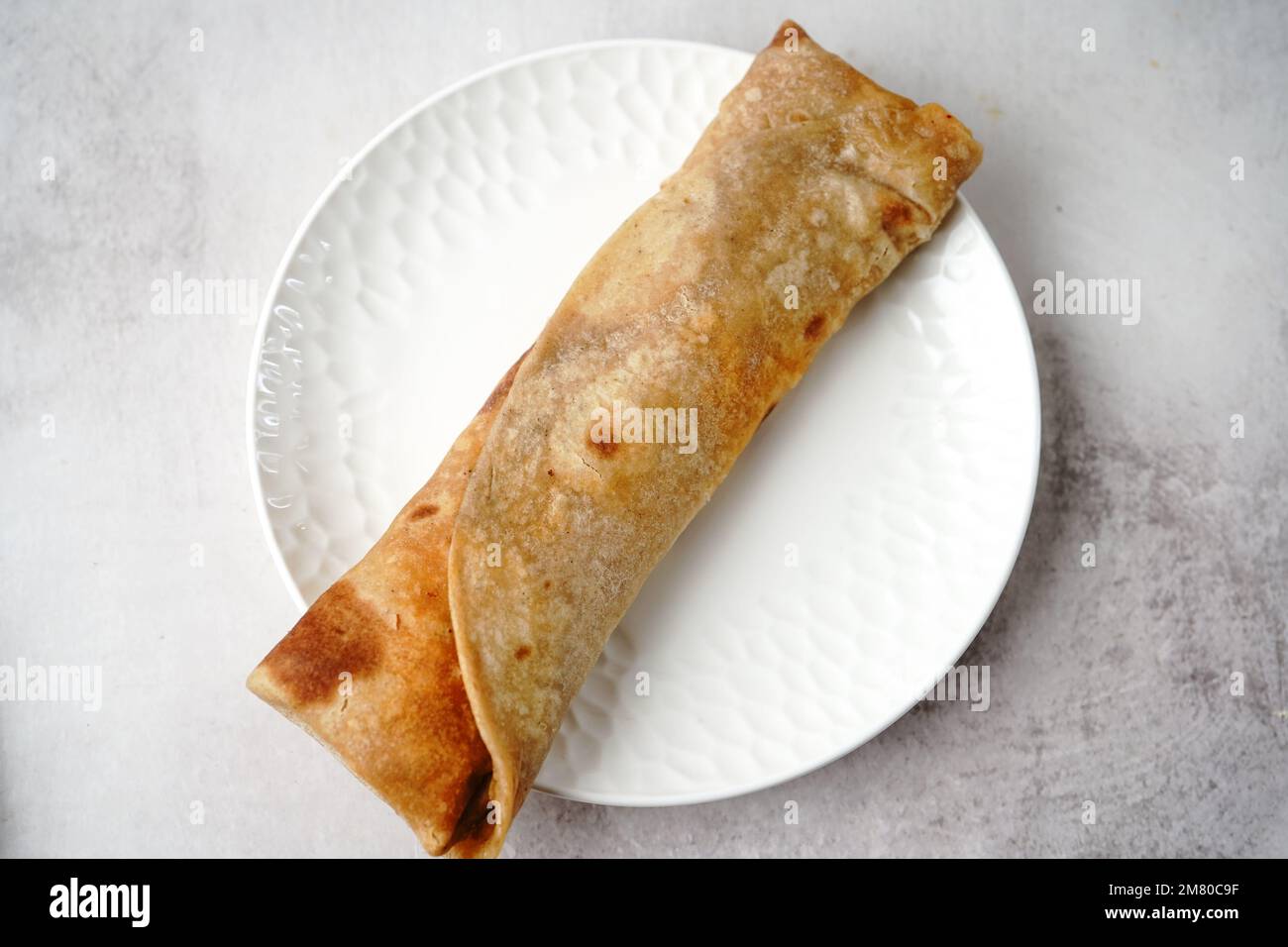 Potato Kathi roll Indian vegetarian wrap with roti, selective focus