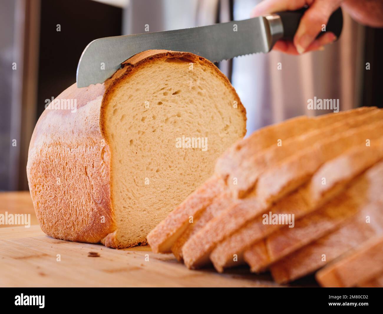 Bread and bread knife on a table in a … – Ottieni la licenza per le foto –  402188 ❘ StockFood