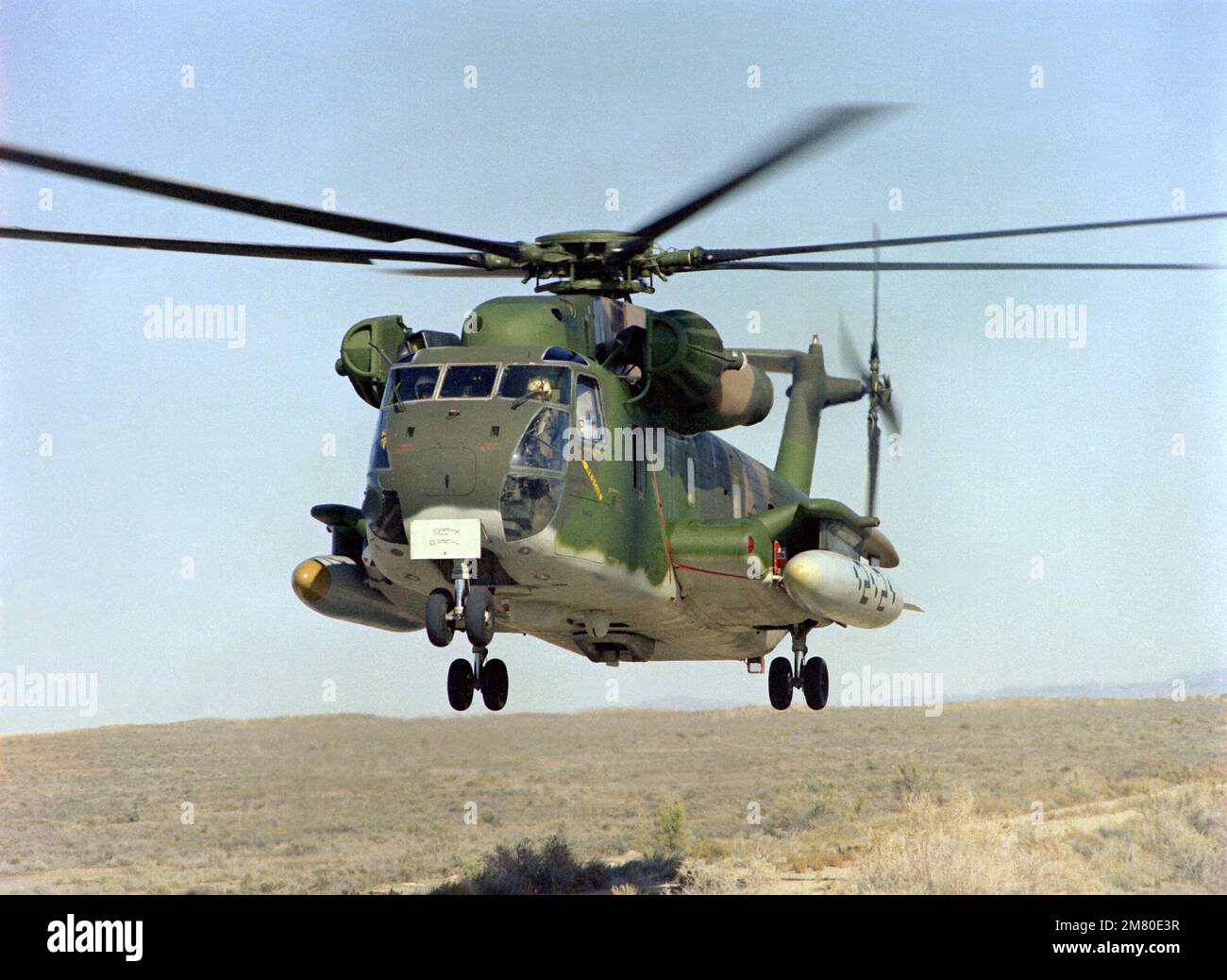 A left front view of an H-53 Super Jolly helicopter hovering over a helipad. Base: Michael Army Air Field State: Utah (UT) Country: United States Of America (USA) Stock Photo