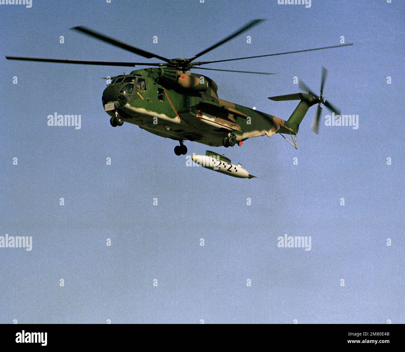 A left underside view of an H-53 helicopter dropping an external fuel tank at the Utah Test and the Training Range. Base: Michael Auxiliary Air Field State: Utah (UT) Country: United States Of America (USA) Stock Photo