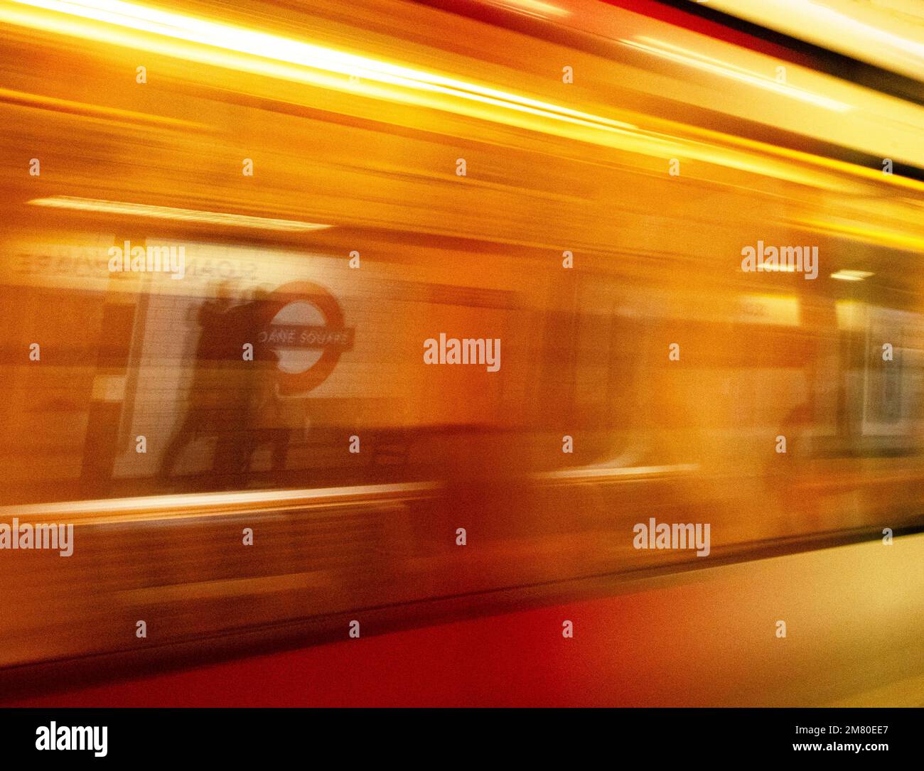 London Underground Sloane Square station, run by Tfl (Transport for London); tube train arriving at high speed, the image blurred Stock Photo