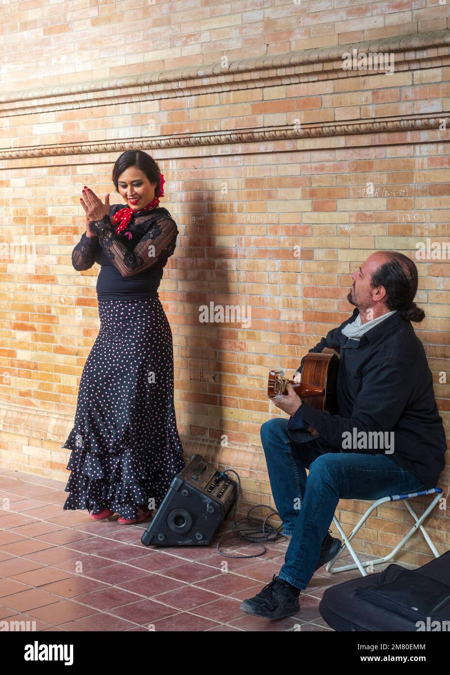 Flamenco guitarist and flamenco dancer performing in the Plaza de España in Seville. Stock Photo