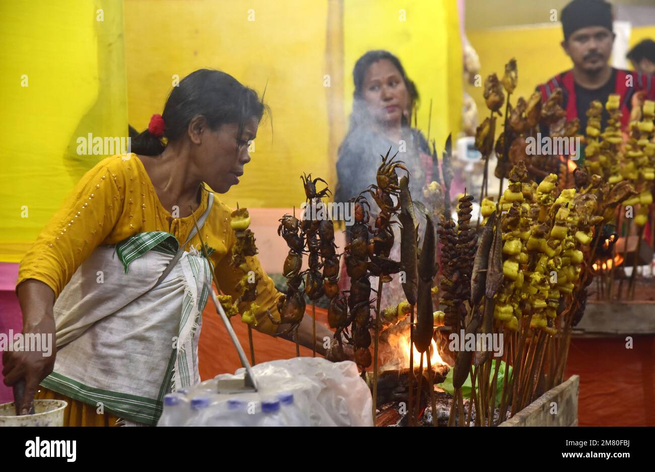 January 11, 2023, Guwahati, Guwahati, India A tribal woman roast fish