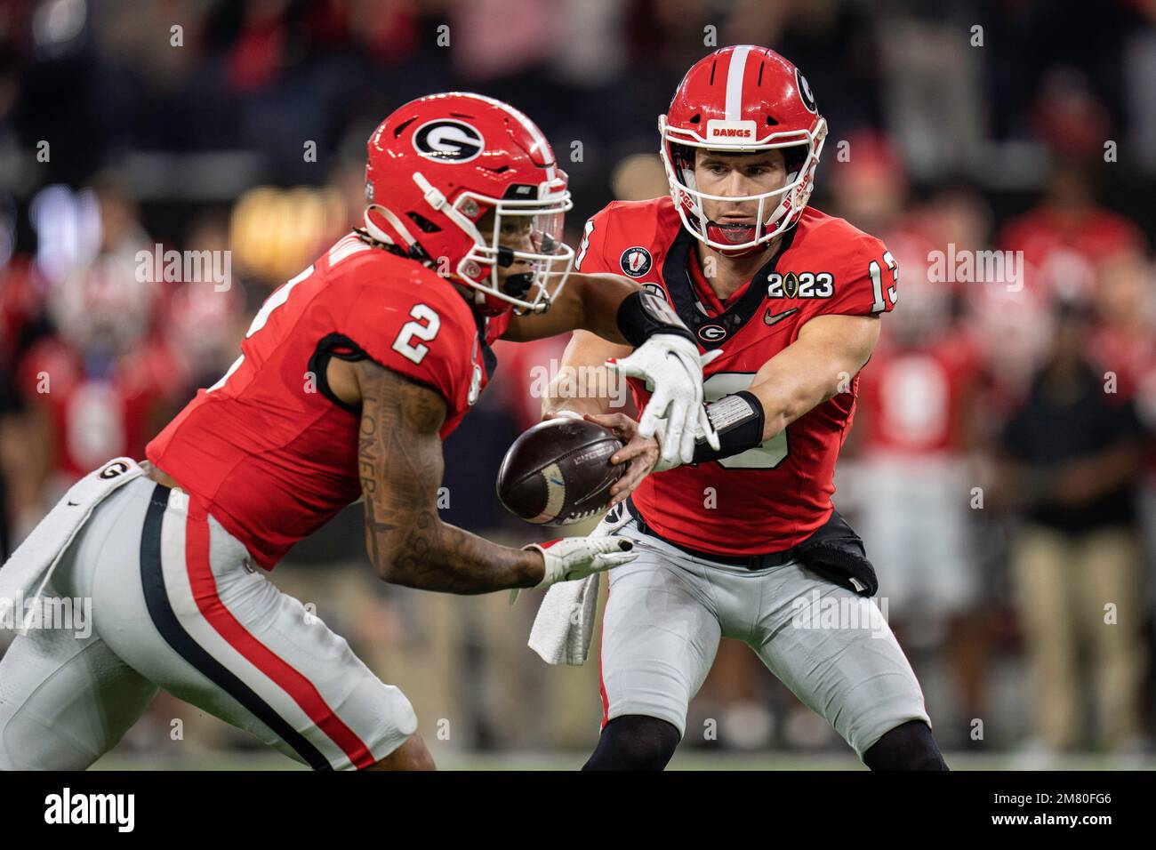 Georgia Bulldogs quarterback Stetson Bennett (13) hands the ball off to running back Kendall Milton (2) during the College Football Playoff National C Stock Photo