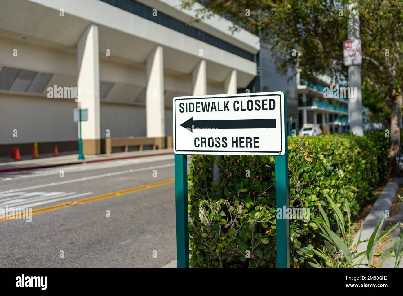 Anaheim, CA, USA – November 1, 2022: Sidewalk Closed Cross Here sign with arrow posted at the Convention Center District in Anaheim, California. Stock Photo