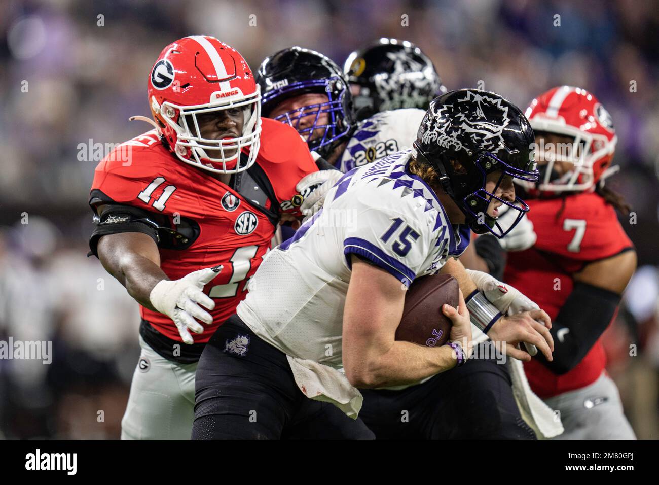 TCU Horned Frogs quarterback Max Duggan (15) tries to escape Georgia Bulldogs linebacker Jalon Walker (11) during the College Football Playoff Nationa Stock Photo