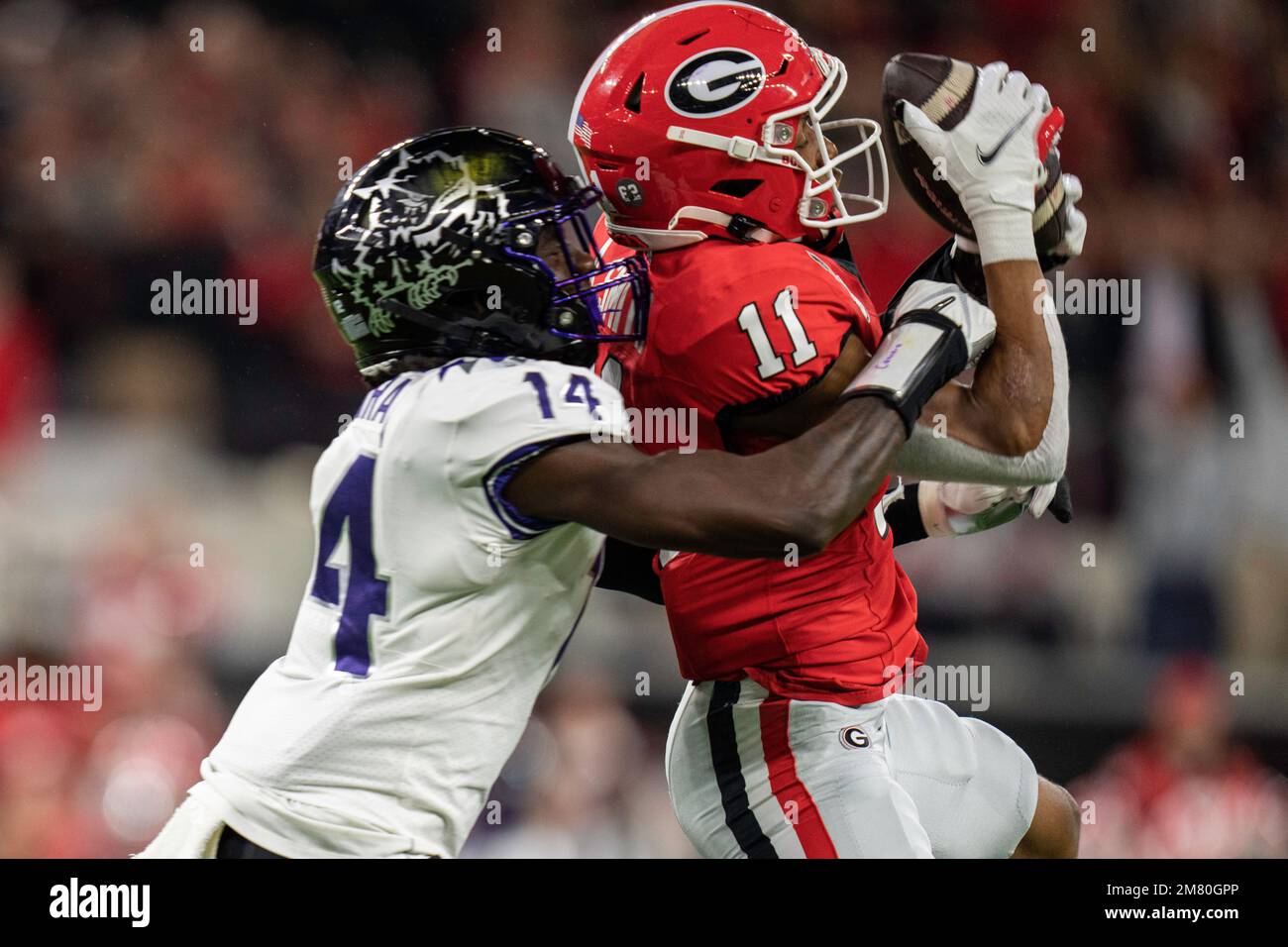 Georgia Bulldogs wide receiver Arian Smith (11) makes a catch against TCU Horned Frogs safety Abraham Camara (14) during the College Football Playoff Stock Photo