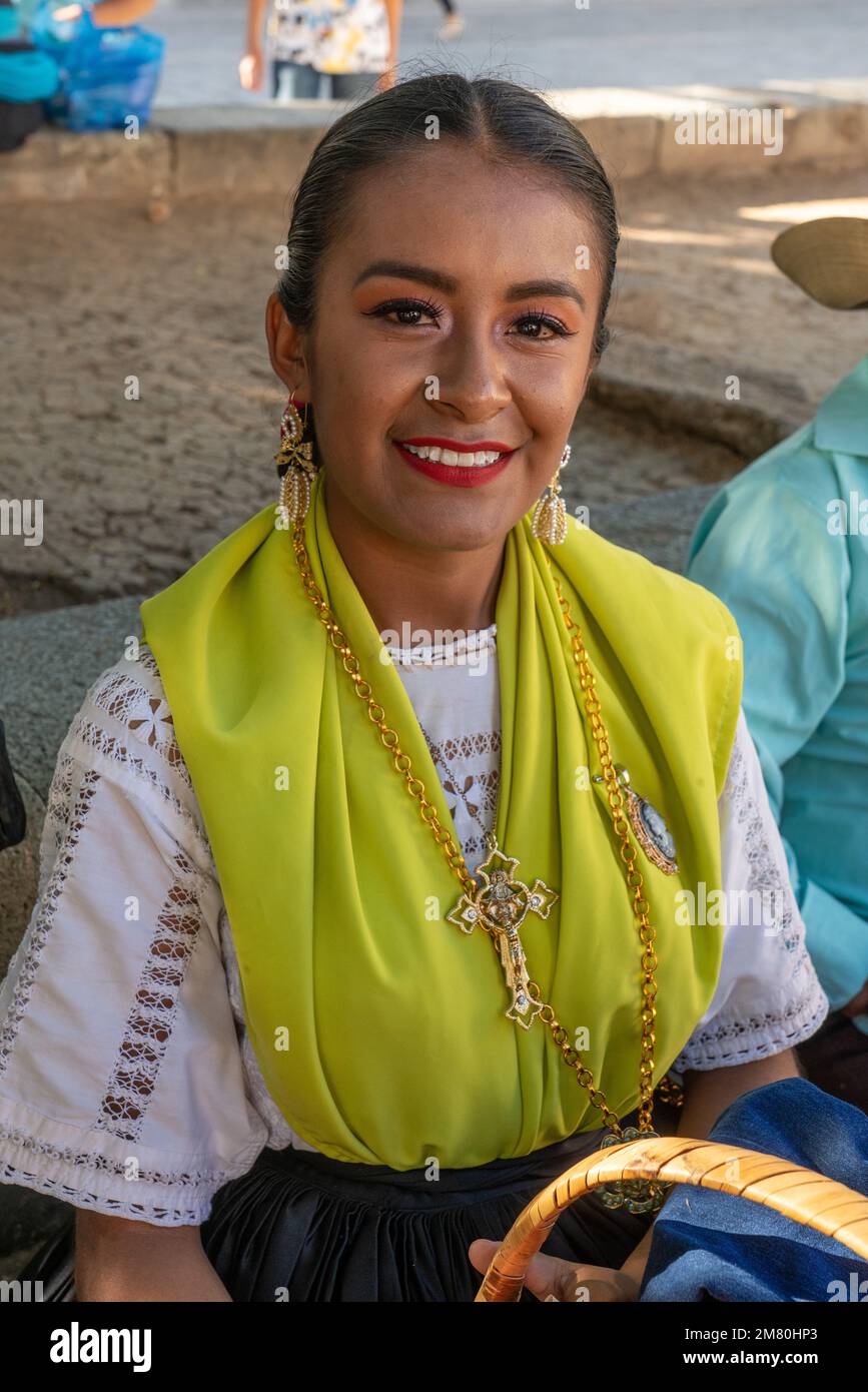 An attractive woman dressed in traditional attire in a plaza in Oaxaca, Mexico. Stock Photo