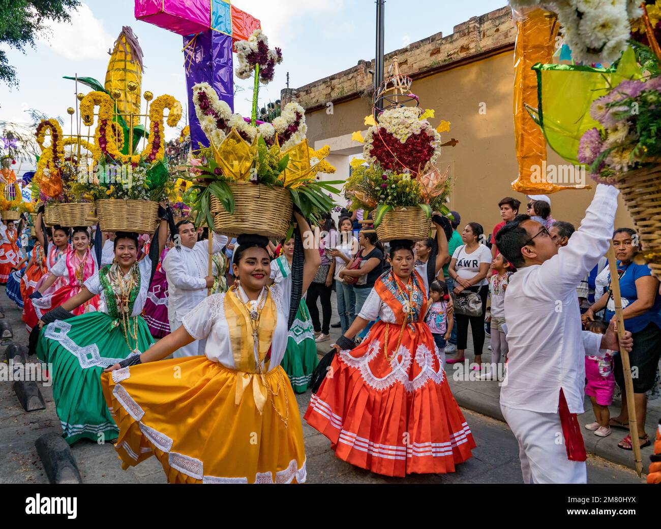 Chinas Oaxaquenas dancers with decorated flower baskets on their heads at the Guelaguetza festival in Oaxaca, Mexico. Stock Photo