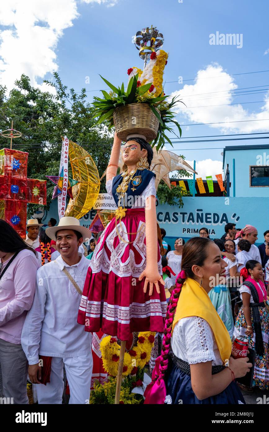 A farolero dancer with a large puppet of a Chinas Oxaquenas dancer at the Guelaguetza dance festival in Oaxaca, Mexico. Stock Photo