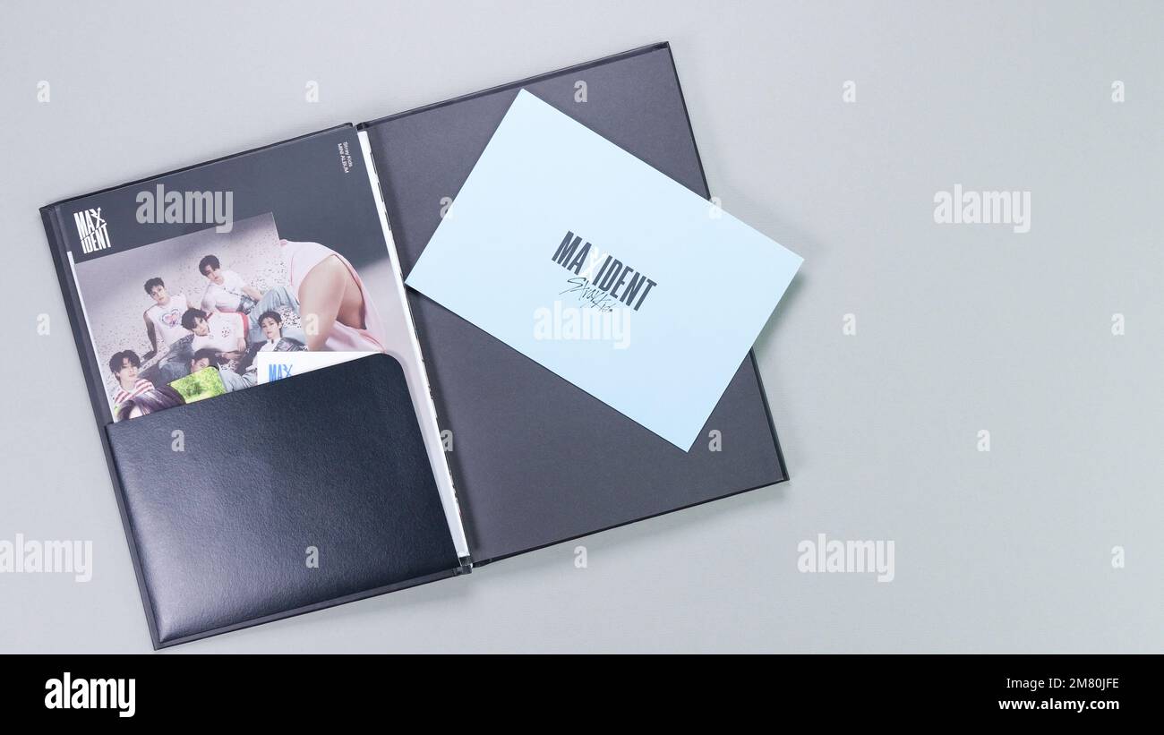 Hands holding Stray Kids MAXIDENT mini Album Box set on grey. Pink music CD. South Korean boy band StrayKids. Space for text. Gatineau, QC Canada - De Stock Photo