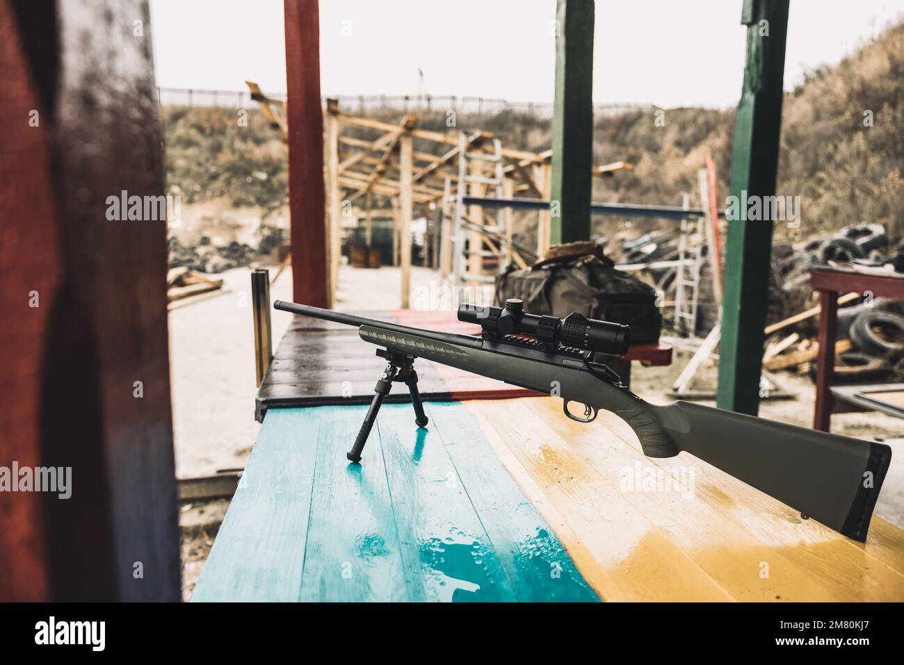 Rifle on a table with ukrainian flag Stock Photo