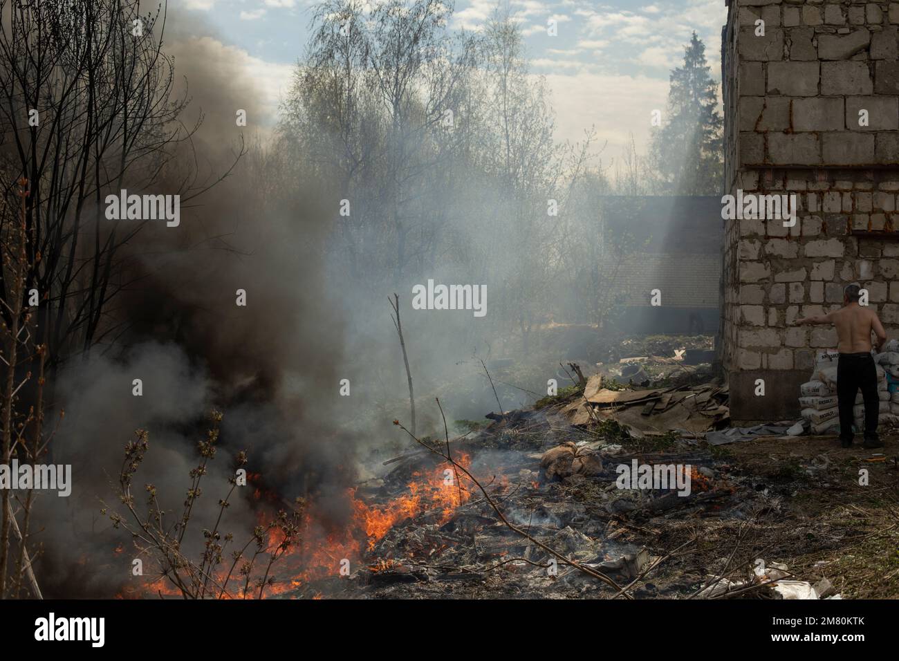 Black smoke from fire. Burning of garbage. Destruction of nature. Environmental disaster. Fire