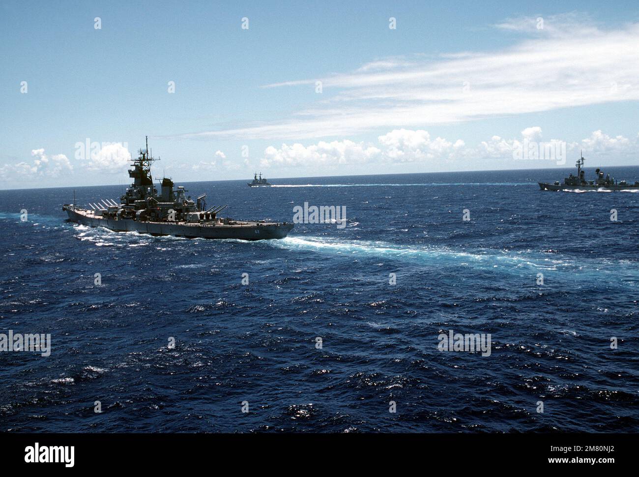 An aerial port quarter view of the battleship USS NEW JERSEY (BB62