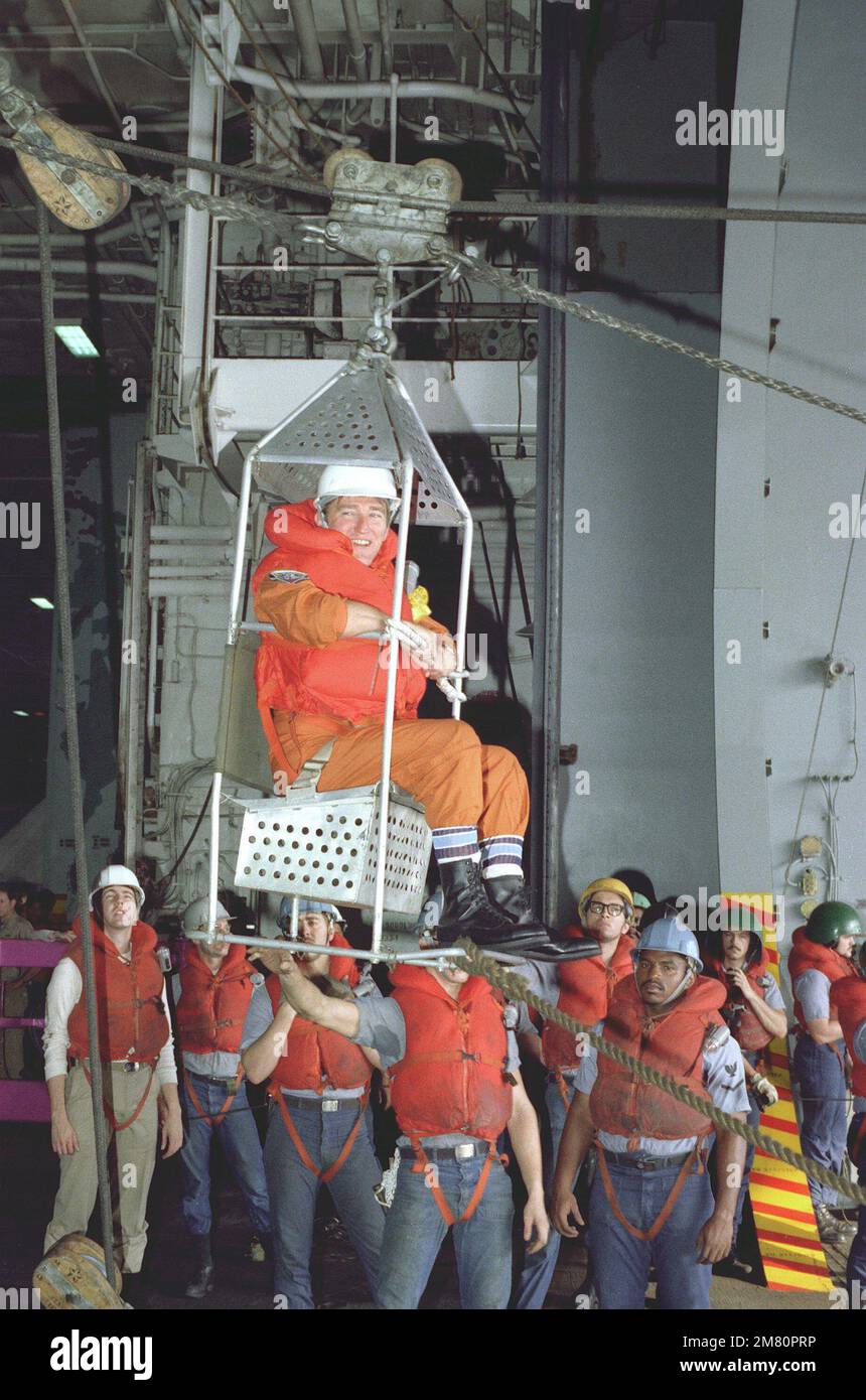 Secretary of the Navy John F. Lehman Jr. is highlined from the nuclear