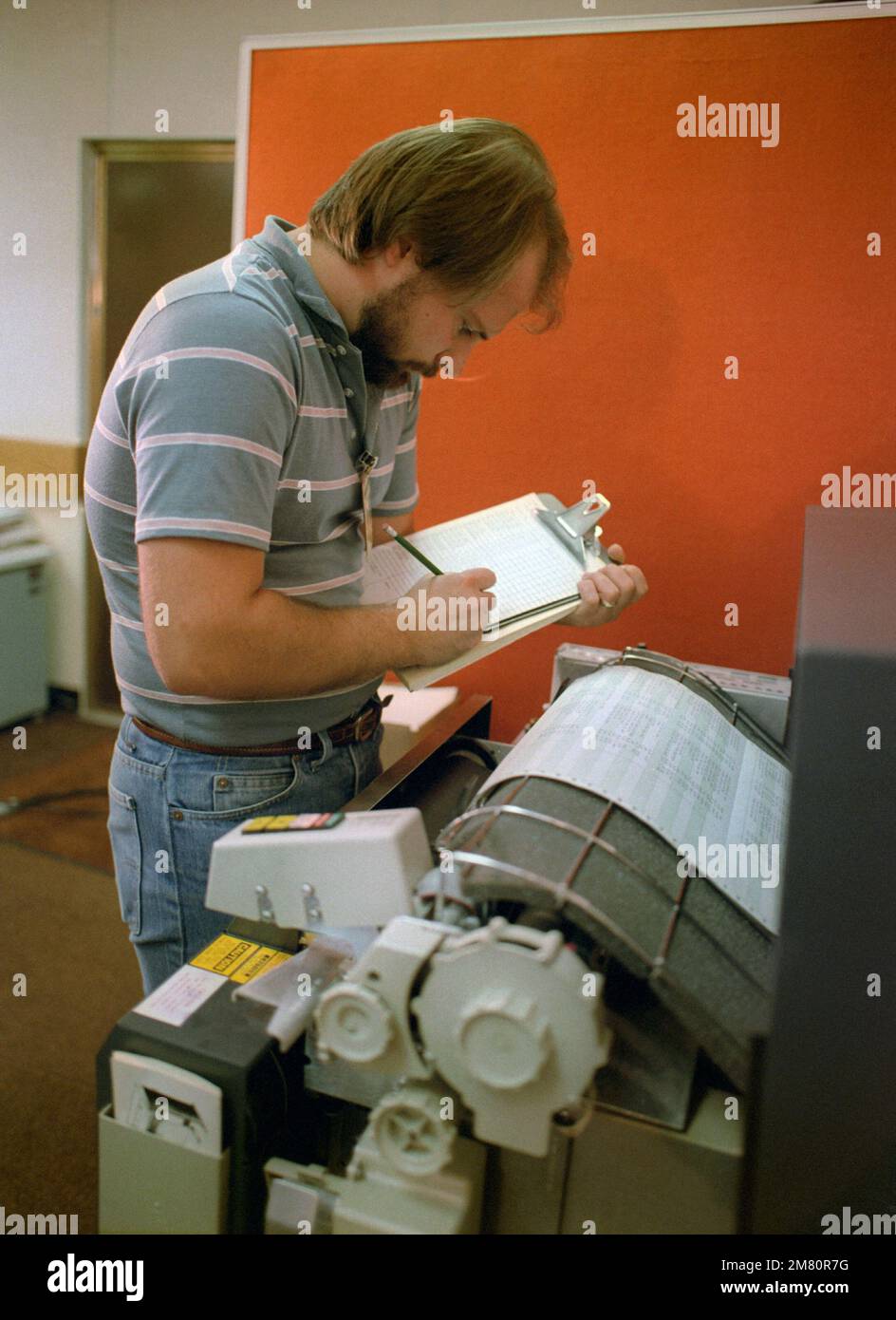 A technician monitors a computer printout while testing the electrical circuits of an MGM-118 Peacekeeper (formerly MX) intercontinental ballistic missile control guidance system. Base: Vandenberg Air Force Base State: California (CA) Country: United States Of America (USA) Stock Photo