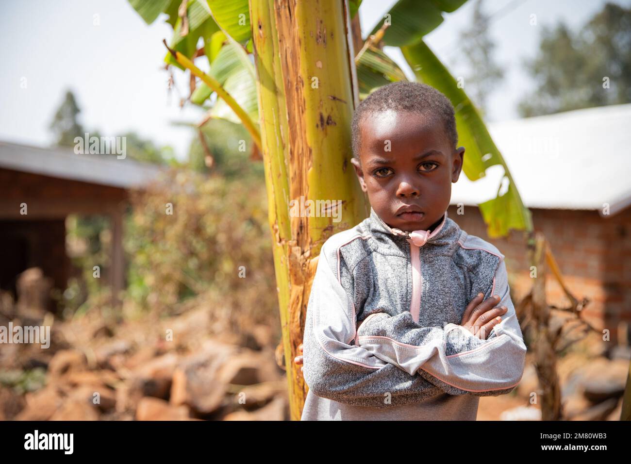 African child in the village with folded arms and angry face Stock Photo
