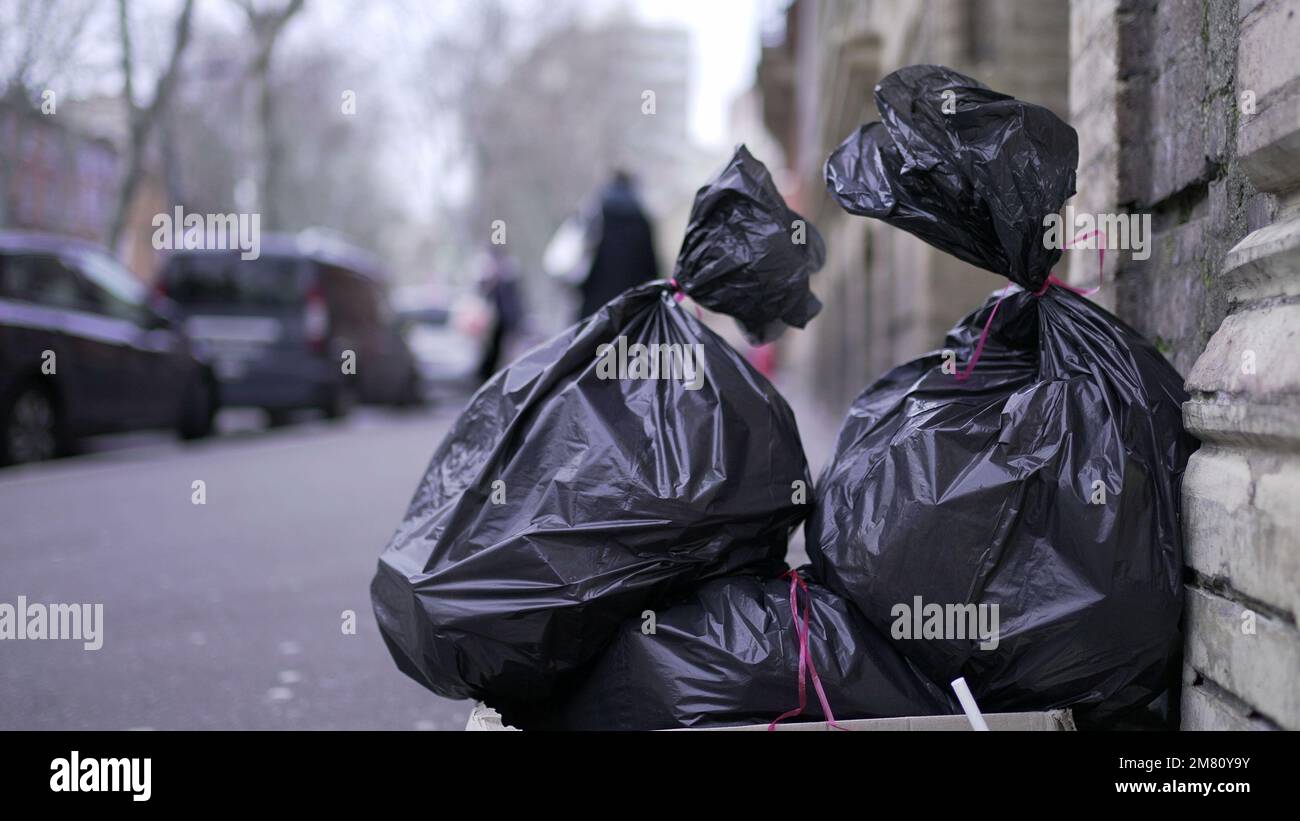 Trash at side road in city for pick-up. Pollution black garbage trash Stock Photo