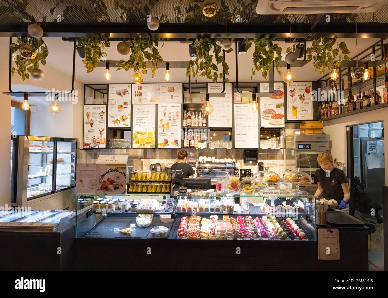 Krakow Cafe interior; Waitresses behind the counter in a cafe serving tea, coffee and cakes near the market square, Krakow Old Town, Krakow Poland Stock Photo