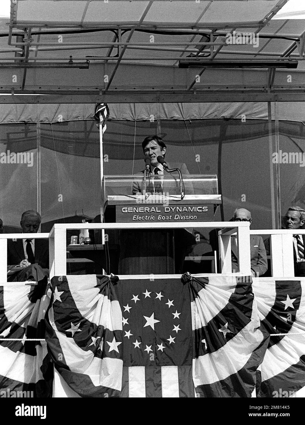 Secretary of the Navy John F. Lehman Jr. addresses guests and spectators attending the launching ceremony for the nuclear-powered strategic missile submarine HENRY M. JACKSON (SSBN-730). Base: Croton State: Connecticut (CT) Country: United States Of America (USA) Stock Photo