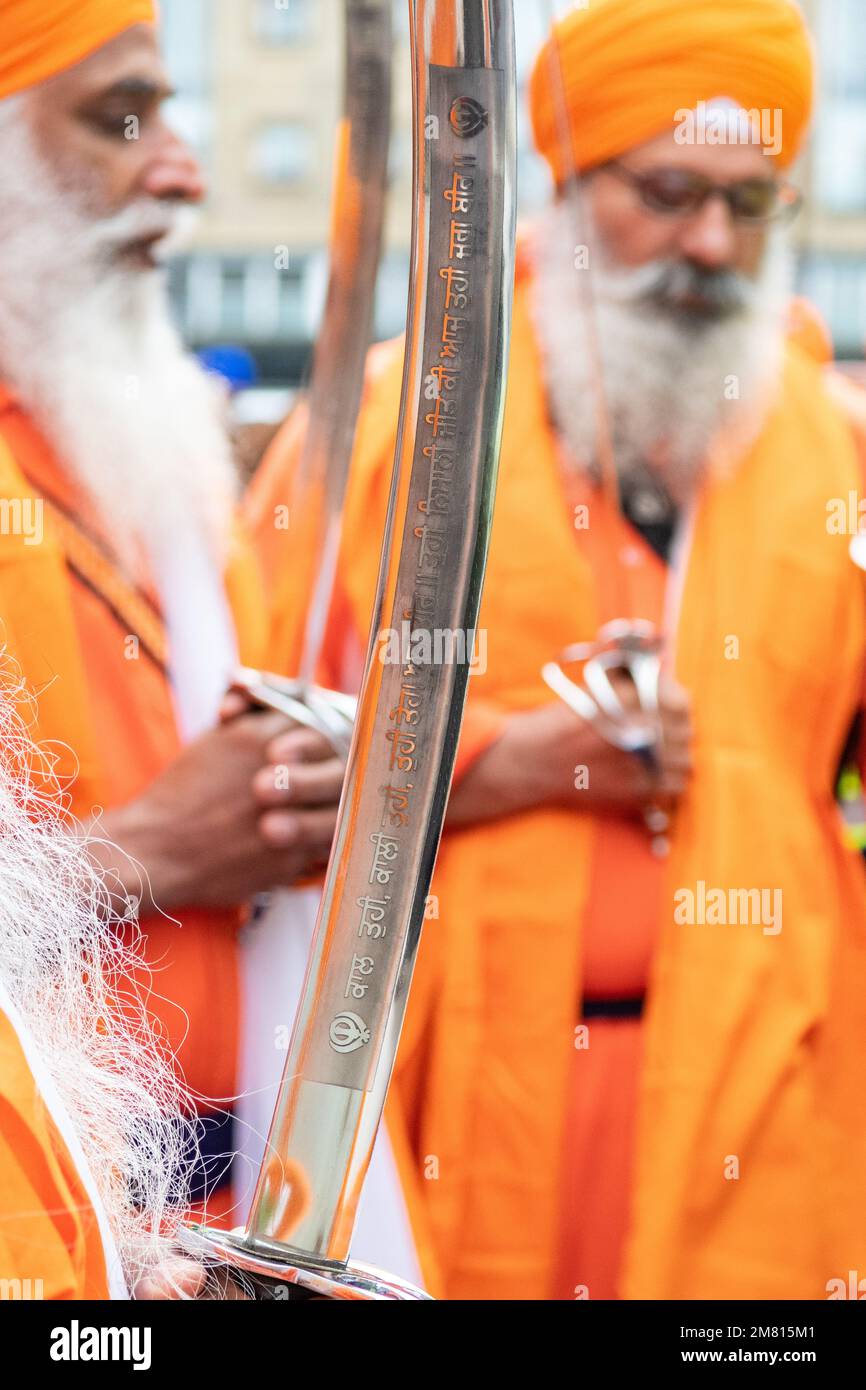 engraved sword and Khanda symbol of Sikh faith at Nagar Kirtan parade for the Vaisakhi (Baisakhi) festival in Glasgow, Scotland, UK Stock Photo