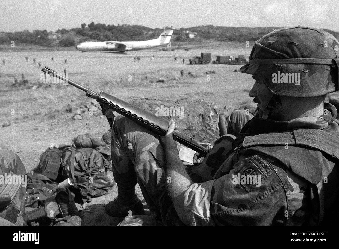 A member of the 82nd Airborne Division stands guard at Point Salines ...