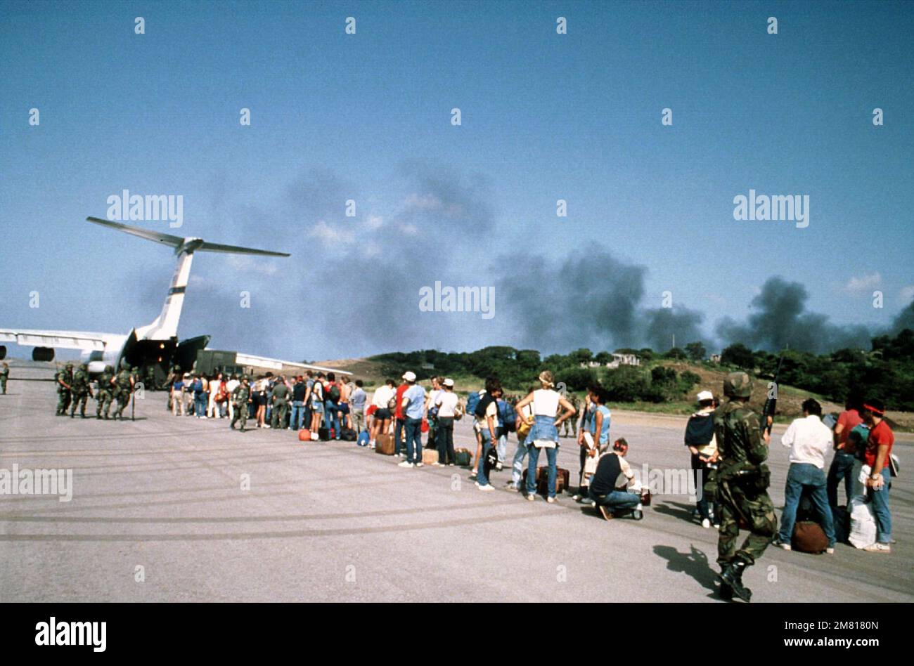 American students wait to board a C-141 Starlifter aircraft for their ...